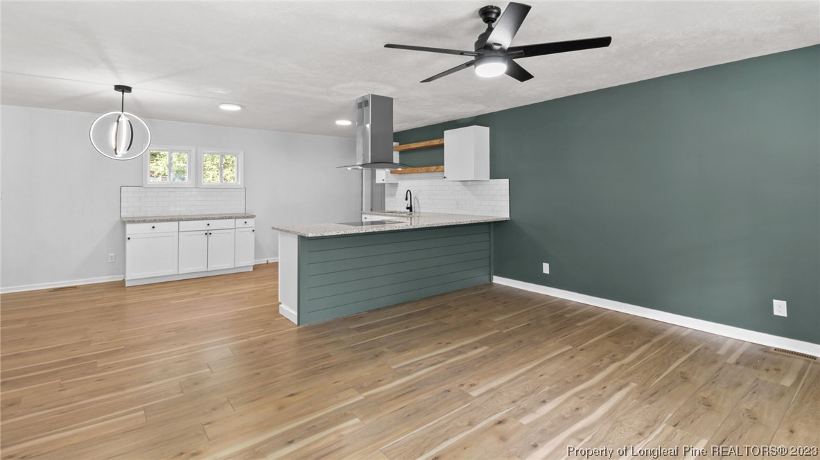 5867 Columbine Road Fayetteville, NC 28306 - Photo 4 of 26 a kitchen with kitchen island a sink stainless steel appliances and cabinets