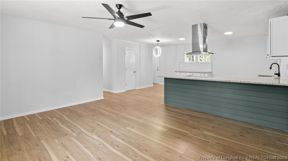 5867 Columbine Road Fayetteville, NC 28306 - Photo 5 of 26 a view of a room with a sink and wooden floor