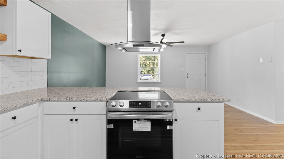 5867 Columbine Road Fayetteville, NC 28306 - Photo 10 of 26 a view of a kitchen with a sink cabinets and wooden floor