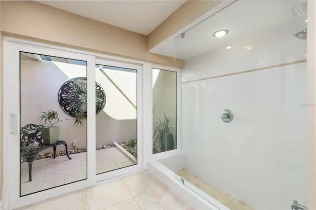 a bathroom with a granite countertop sink a mirror and bathtub