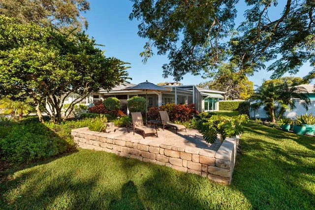 a view of yard with swimming pool and trees