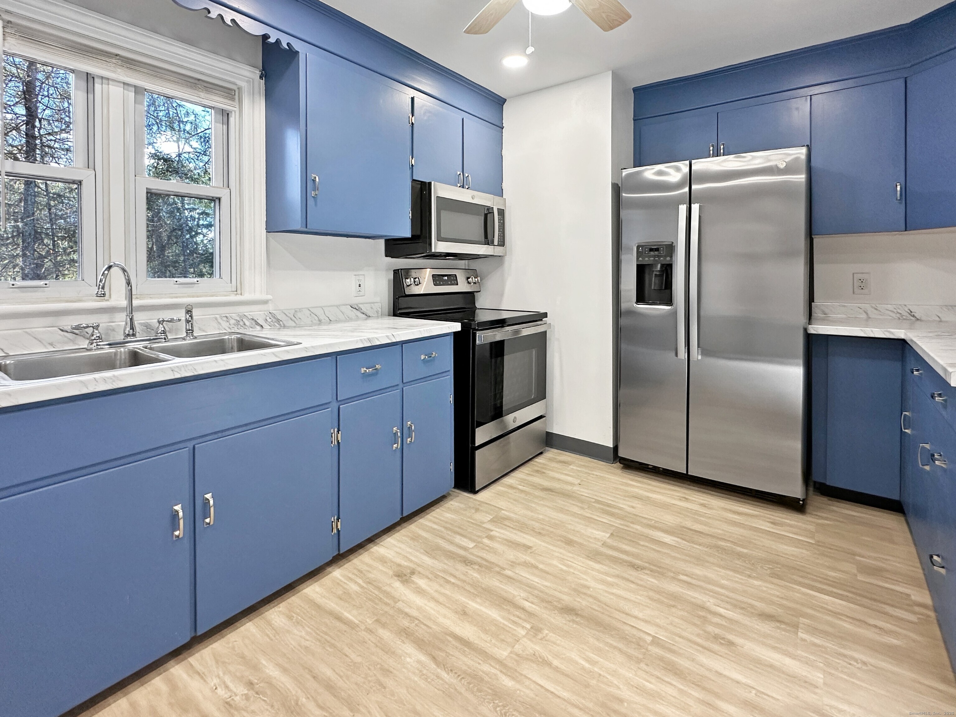 5 Chappell Street Chaplin, CT 06235 - Photo 15 of 40 a kitchen with stainless steel appliances a sink cabinets and a window