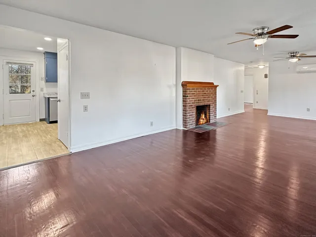 an empty room with wooden floor and closet