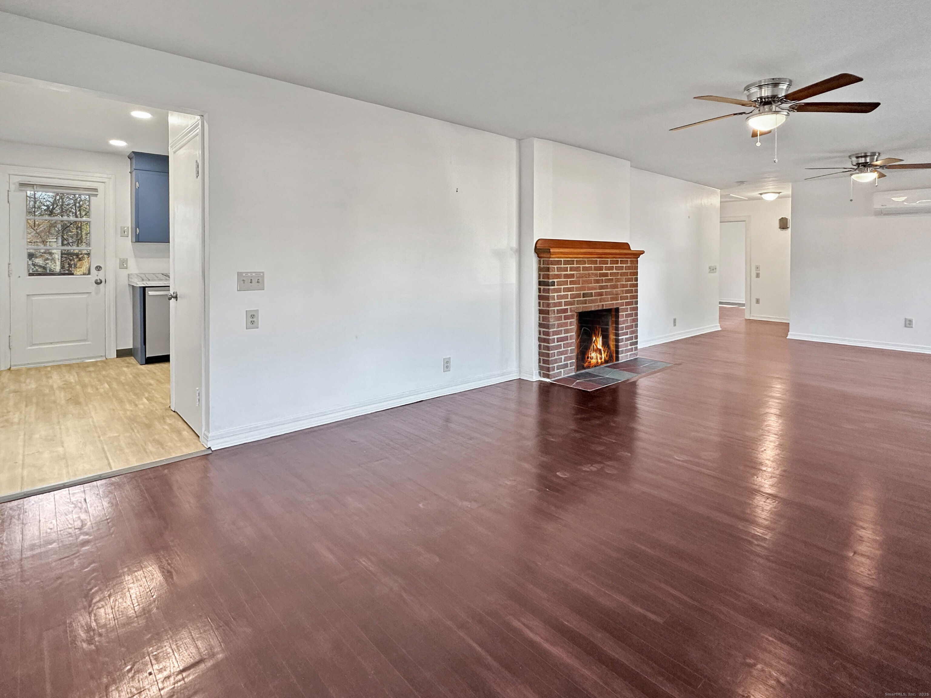 5 Chappell Street Chaplin, CT 06235 - Photo 18 of 40 an empty room with wooden floor fireplace and mountain view