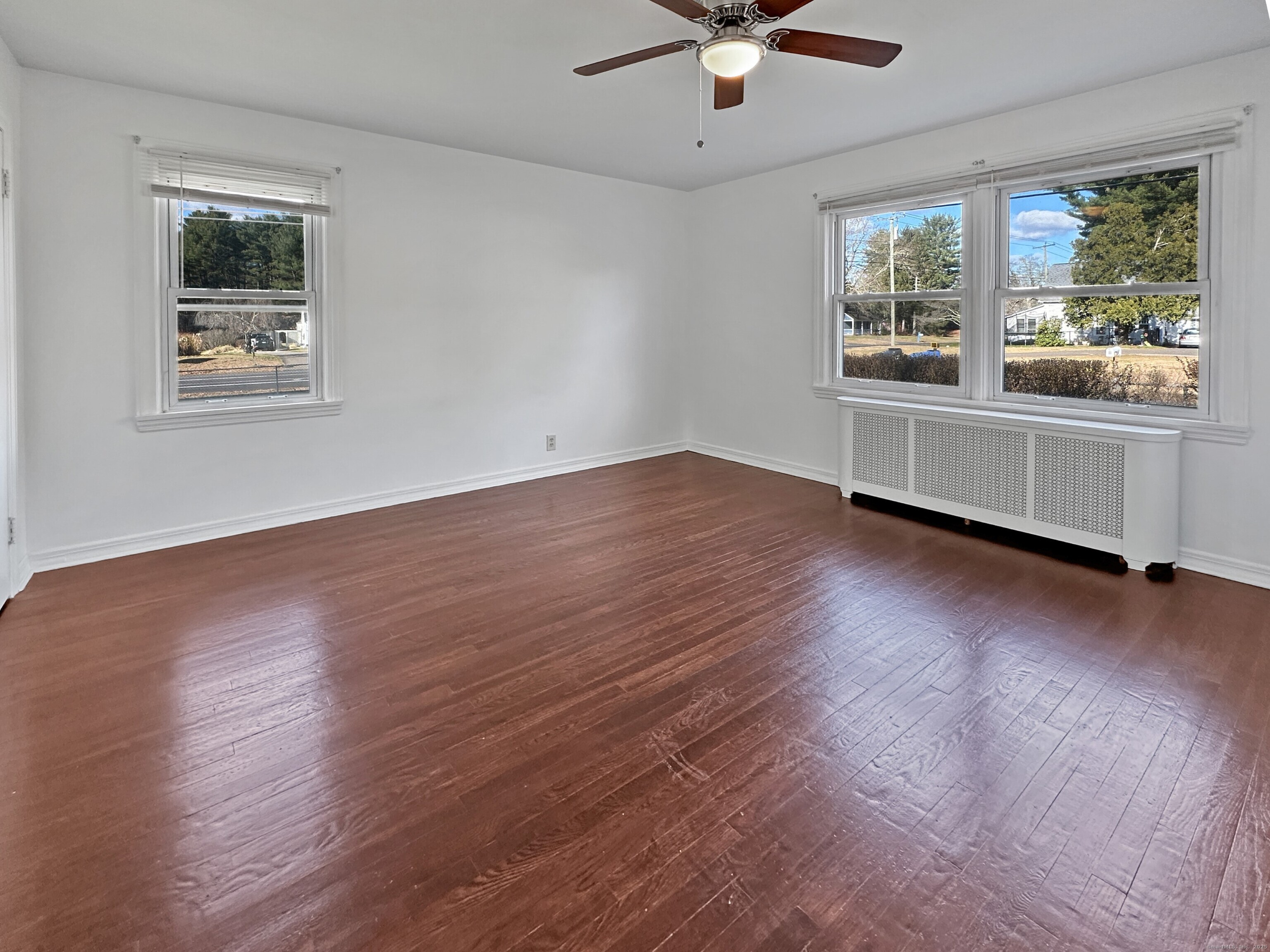 5 Chappell Street Chaplin, CT 06235 - Photo 22 of 40 a view of an empty room with a window and wooden floor