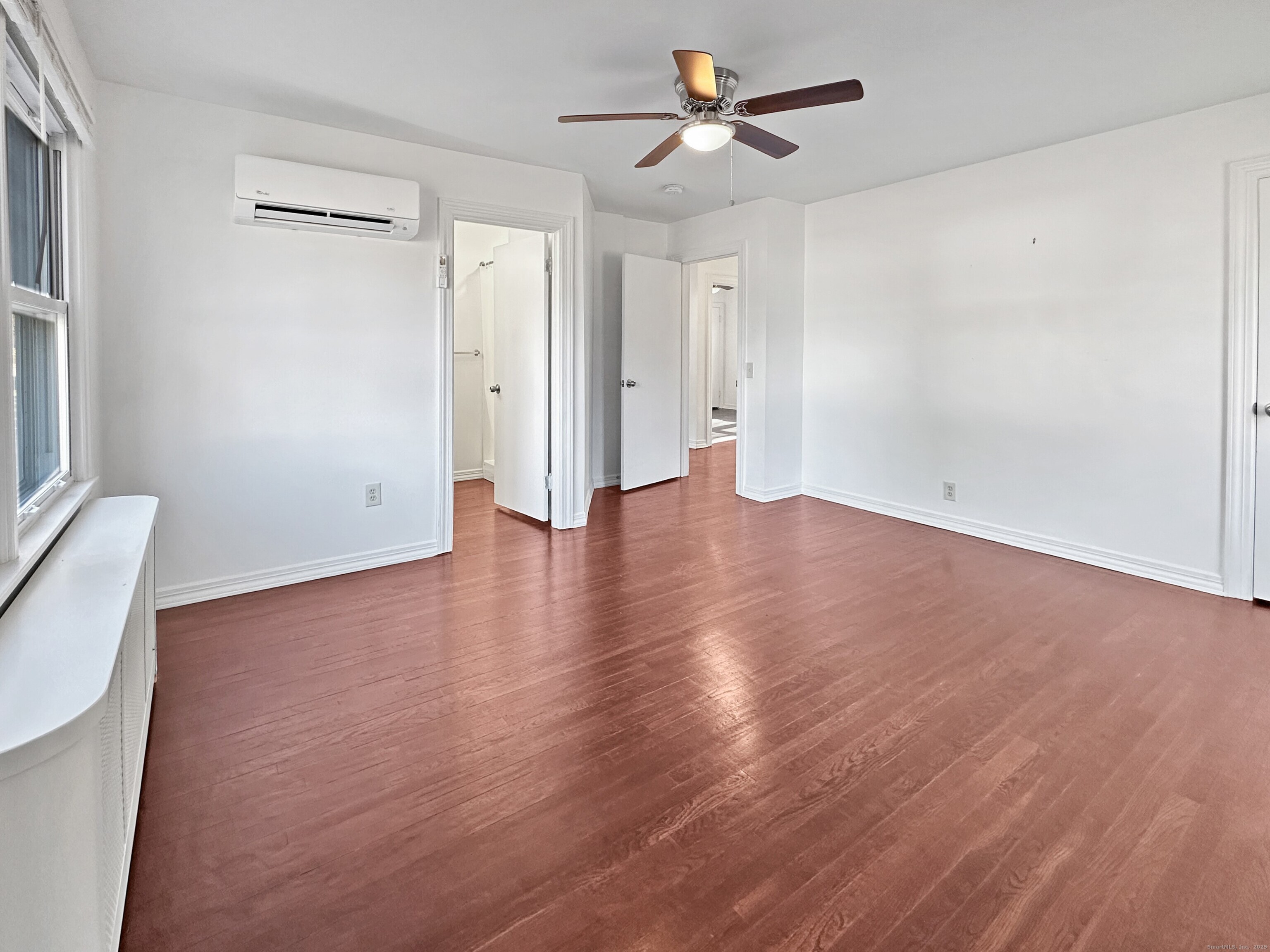 5 Chappell Street Chaplin, CT 06235 - Photo 23 of 40 an empty room with wooden floor and ceiling fan