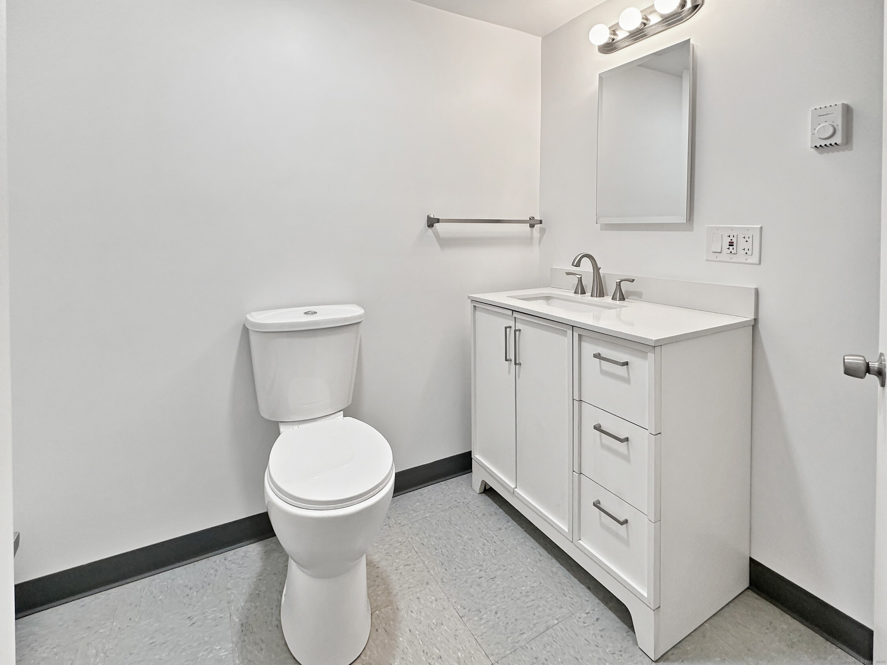 5 Chappell Street Chaplin, CT 06235 - Photo 32 of 40 a bathroom with a toilet sink and mirror