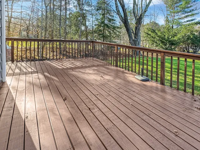 a view of house with small yard and wooden fence