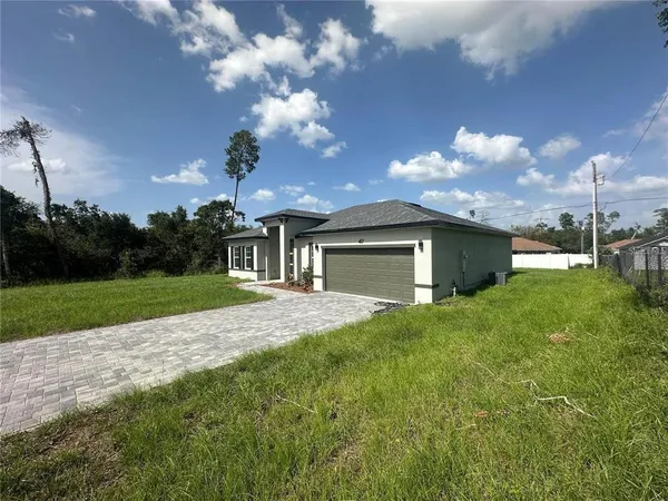 a front view of a house with yard and green space