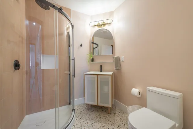 a bathroom with a toilet a sink and shower