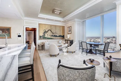 a living room with furniture and kitchen view