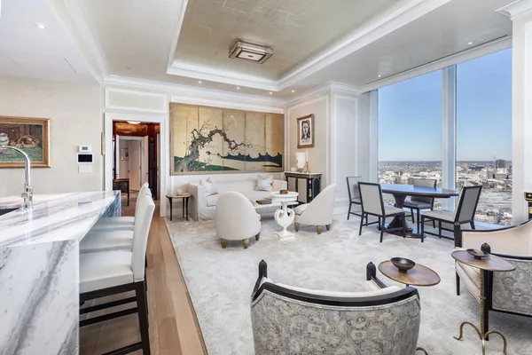 a living room with furniture and kitchen view