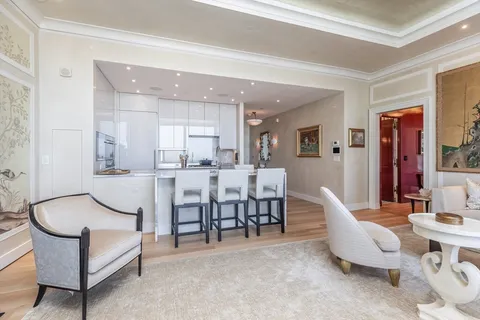a living room with furniture a dining table and kitchen view