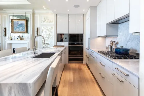 a large kitchen with stainless steel appliances granite countertop a stove a sink and a refrigerator