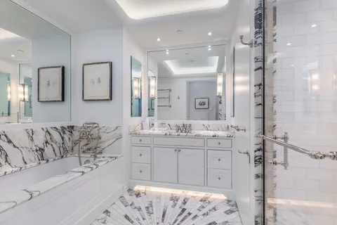 a spacious bathroom with a granite countertop sink mirror and bathtub