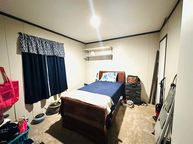 a bedroom with a bed and a dresser