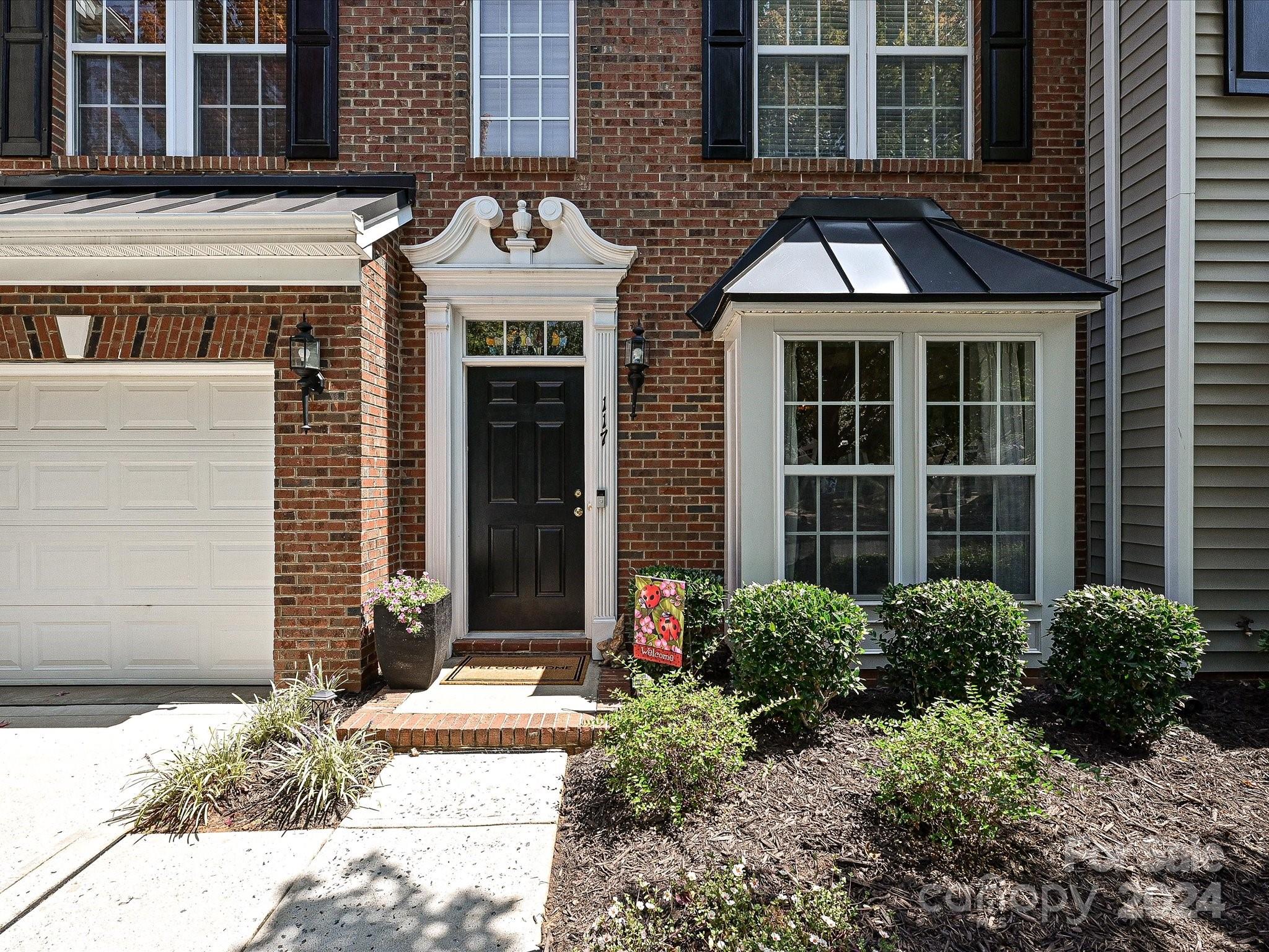 117 Snead Road Fort Mill, SC 29715 - Photo 2 of 36 a front view of a building with a garden and plants