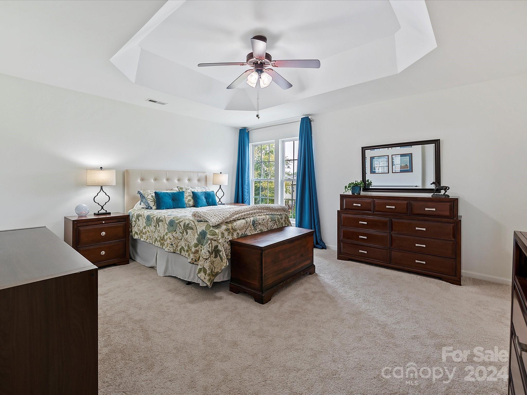 117 Snead Road Fort Mill, SC 29715 - Photo 24 of 36 a spacious bedroom with a bed and ceiling fan