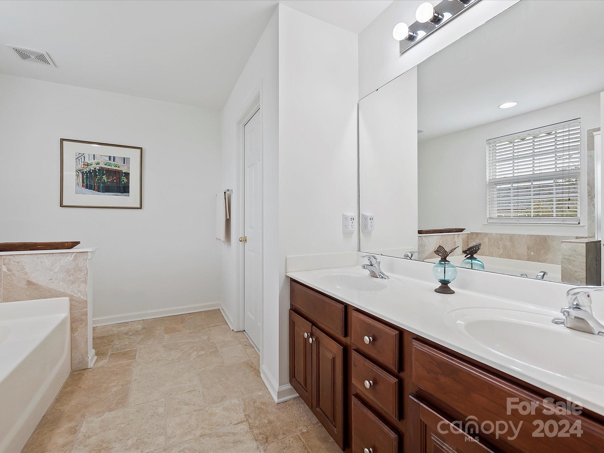 117 Snead Road Fort Mill, SC 29715 - Photo 26 of 36 a spacious bathroom with a double vanity sink and a mirror