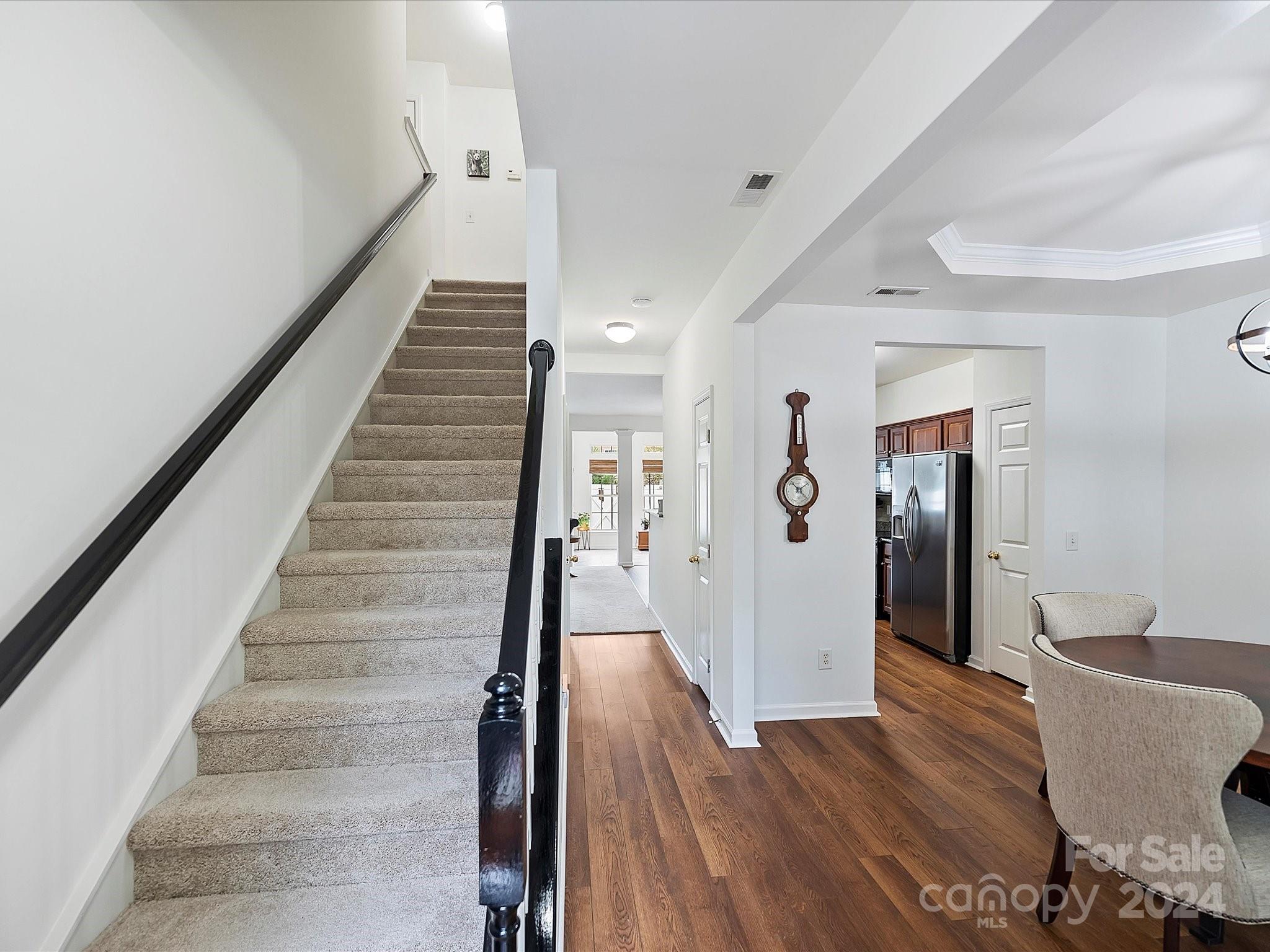 117 Snead Road Fort Mill, SC 29715 - Photo 3 of 36 a view of a hallway with wooden floor and stairs