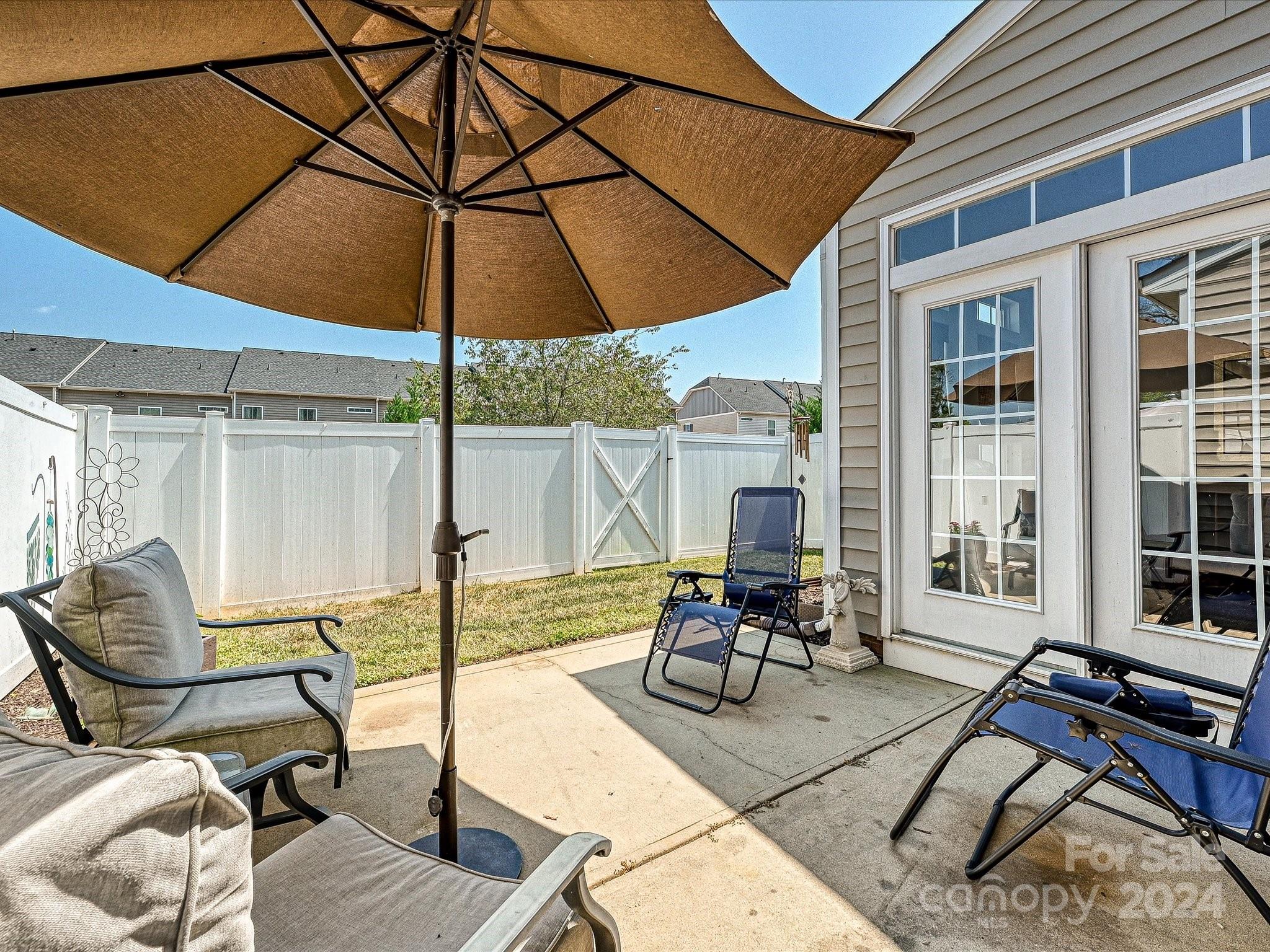 117 Snead Road Fort Mill, SC 29715 - Photo 34 of 36 a view of a patio with table and chairs under an umbrella