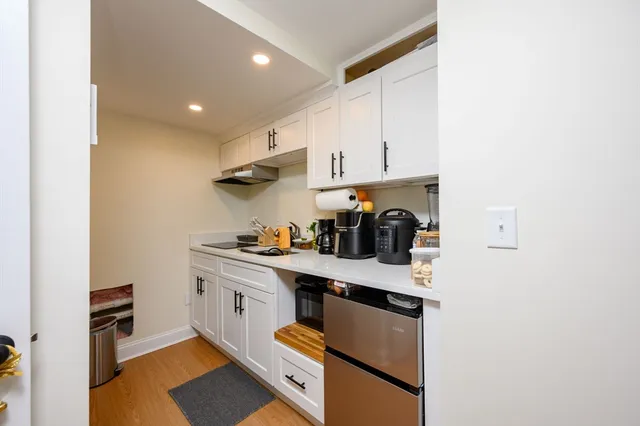 a kitchen with stainless steel appliances granite countertop a sink stove and cabinets