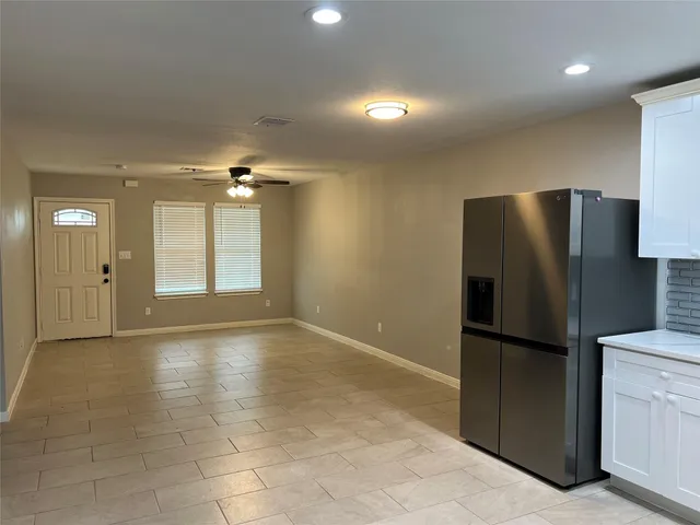 a view of a kitchen with a refrigerator and a sink