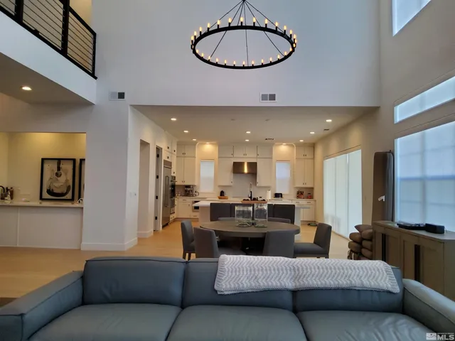a living room with furniture and kitchen view