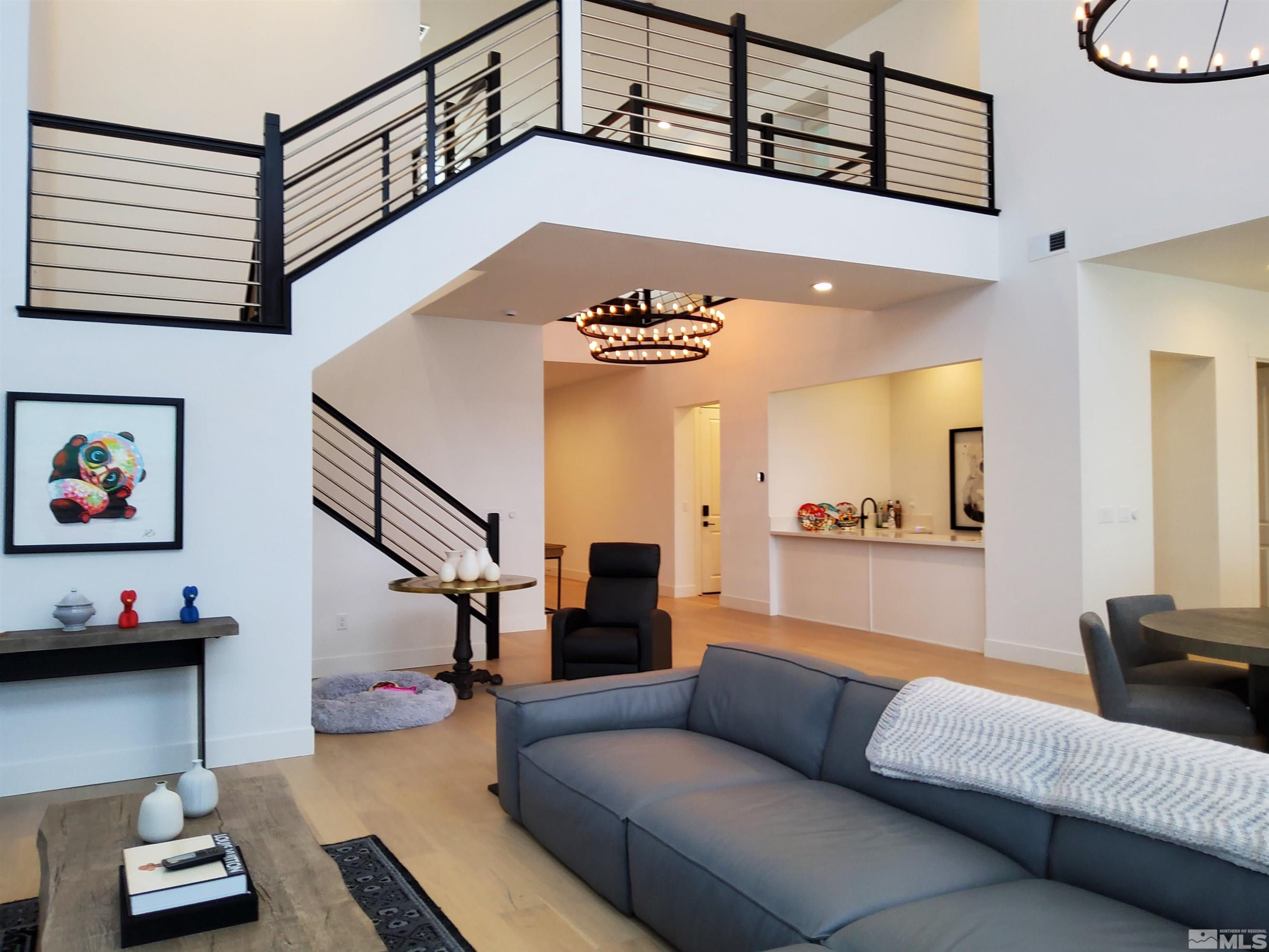 5449 Side Saddle Trail Reno, NV 89511 - Photo 14 of 35 a living room with furniture stairs and a chandelier