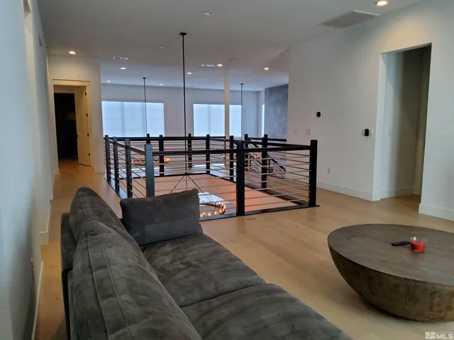 a living room with furniture and a ceiling fan