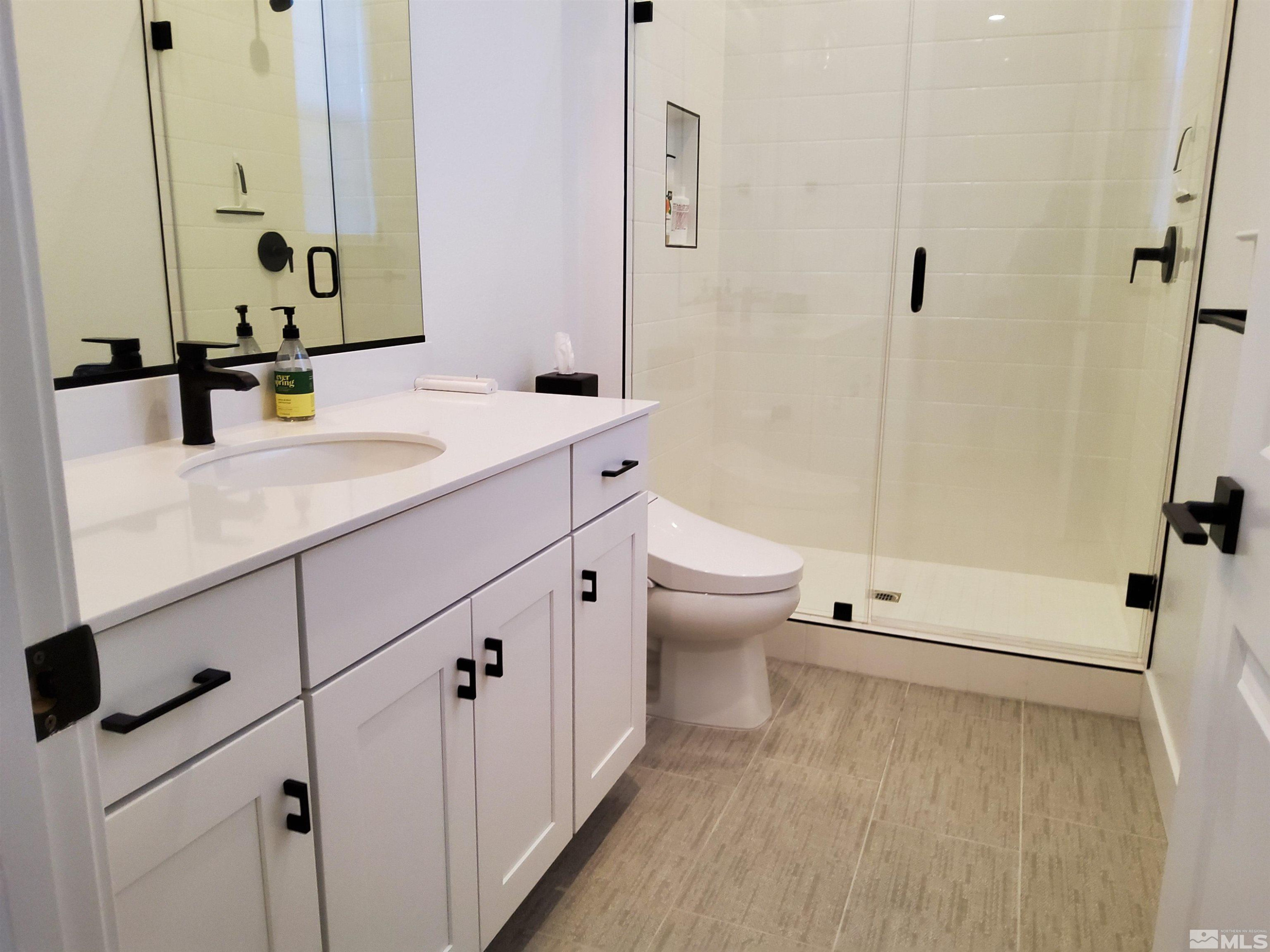 5449 Side Saddle Trail Reno, NV 89511 - Photo 22 of 35 a bathroom with a sink a toilet and a large mirror