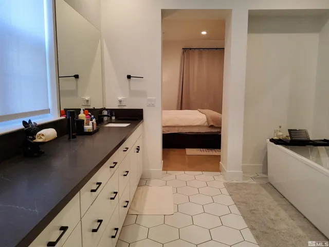 a kitchen with granite countertop a sink a stove and cabinets