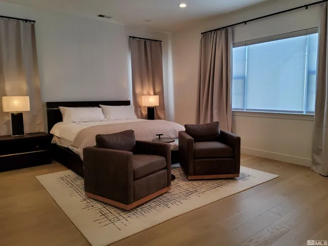 a bedroom with a bed couch and a window