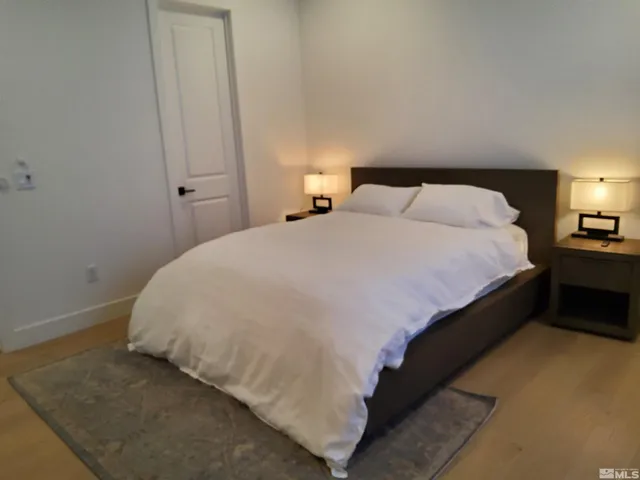 a large bed sitting in a bedroom next to a lamp