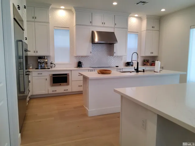 a kitchen with stainless steel appliances a stove sink microwave and cabinets