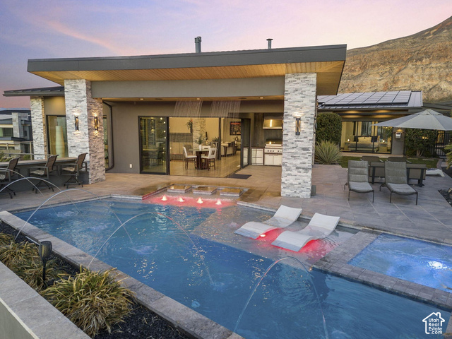3652 South Cypress Road Hurricane, UT 84737 - Photo 74 of 81 Outdoor living space with a swimming pool, integrated spa, and an outdoor kitchen featuring a built-in grill