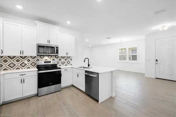 a kitchen with stainless steel appliances granite countertop a stove and a sink