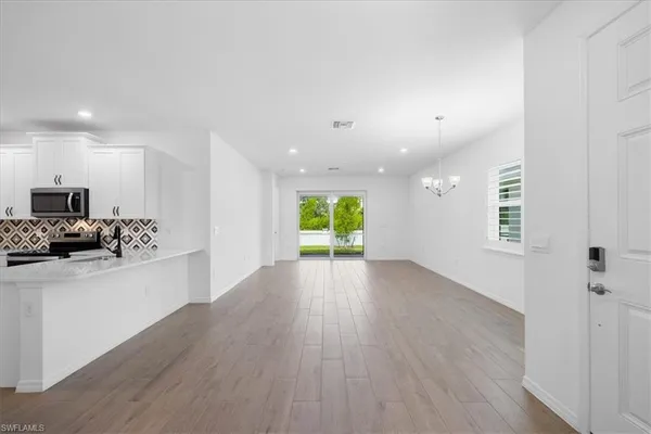 a view of a kitchen with a sink and a large window