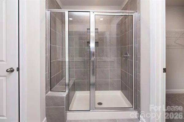 a bathroom with a glass shower door
