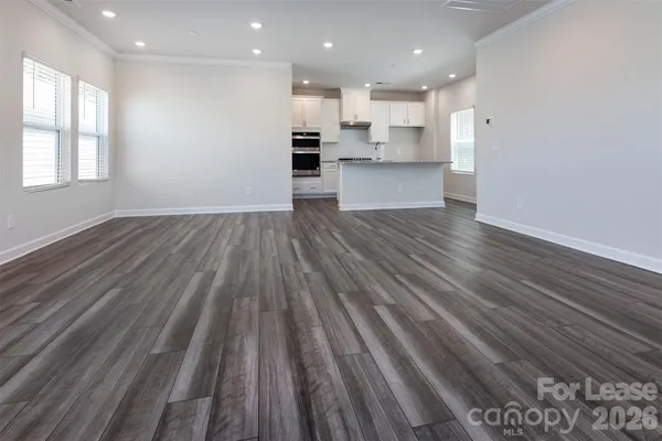 a view of kitchen view wooden floors appliances and cabinets