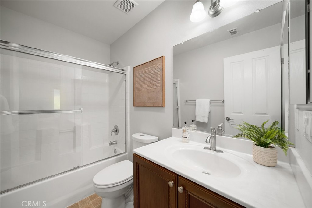 1012 La Costa Court Atascadero, CA 93422 - Photo 11 of 21 a bathroom with a sink a toilet and a large mirror