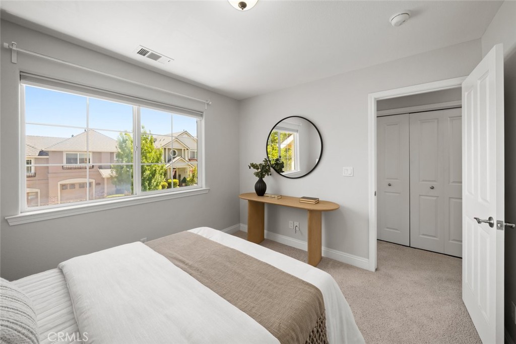 1012 La Costa Court Atascadero, CA 93422 - Photo 13 of 21 a bedroom with a bed a window and a chandelier