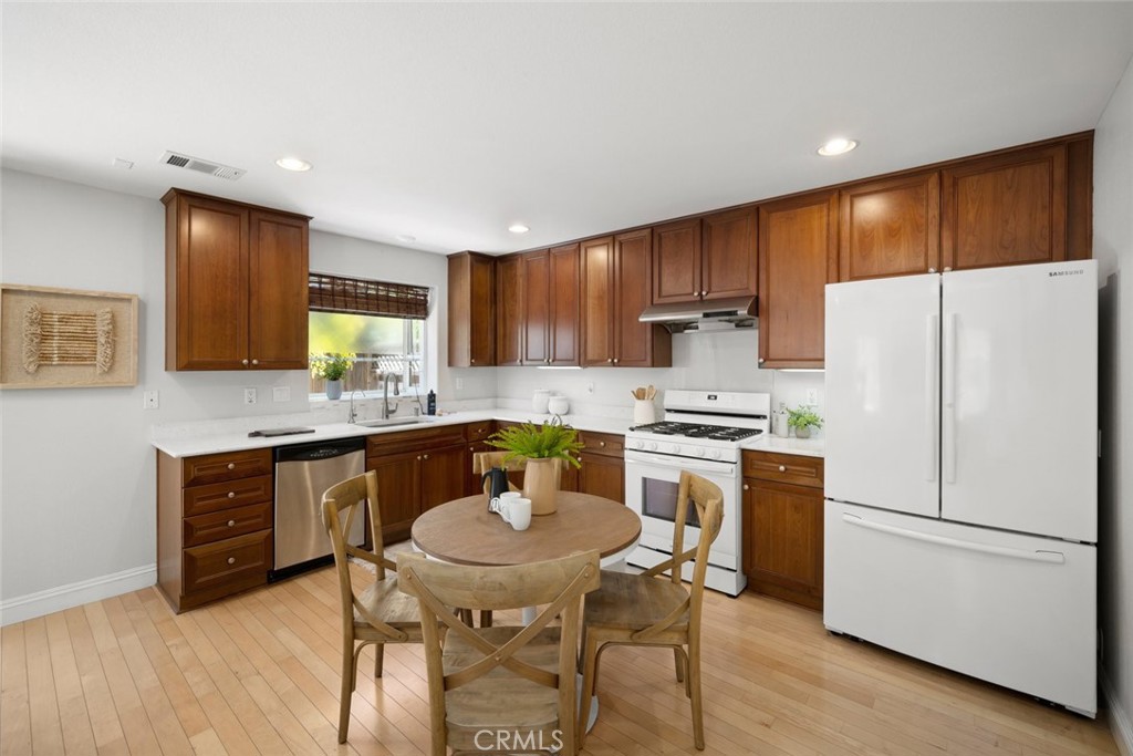 1012 La Costa Court Atascadero, CA 93422 - Photo 3 of 21 a kitchen with stainless steel appliances a refrigerator a stove a sink a dining table and chairs