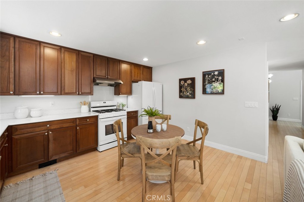 1012 La Costa Court Atascadero, CA 93422 - Photo 8 of 21 a kitchen with a dining table chairs and refrigerator