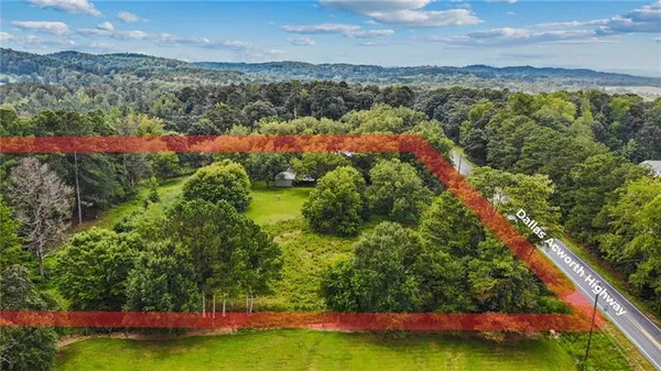 an aerial view of residential houses with outdoor space and lake view