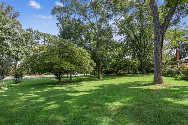 a view of field with trees in the background