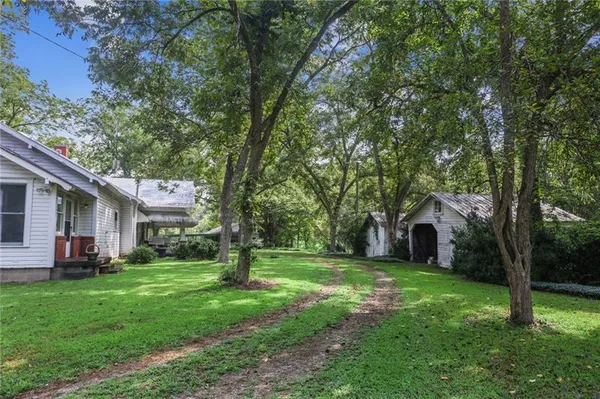 a view of a house with backyard and sitting area