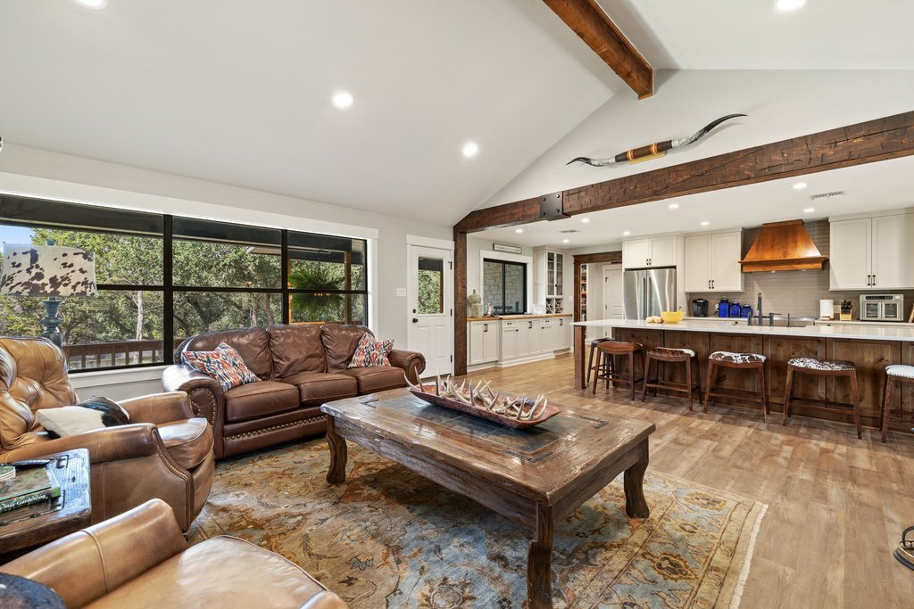 23644 Nameless Road Leander, TX 78641 - Photo 6 of 40 An open concept living area blends rustic beams and contemporary finishes, creating a comfortable gathering space.