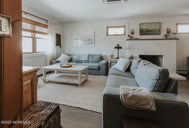 a view of a room with furniture and wooden floor