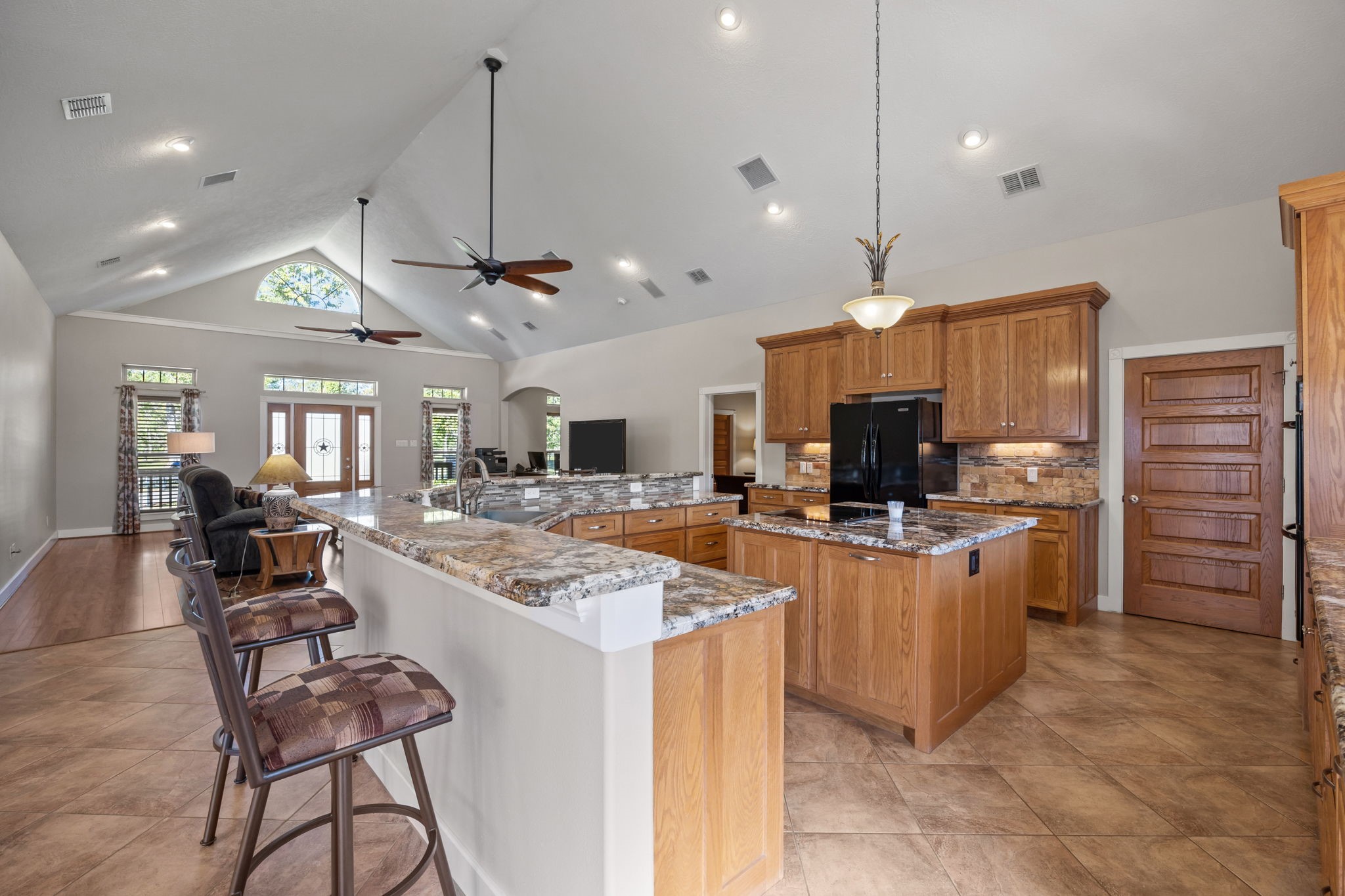 3998 County Road 612 Angleton, TX 77515 - Photo 14 of 47 a large kitchen with kitchen island a large island in the center